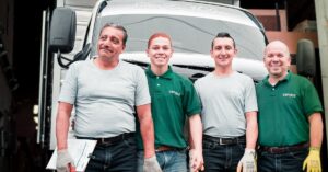 working men in front of a truck