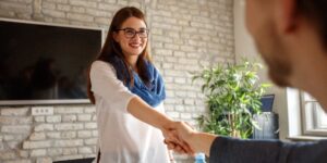 woman shaking hands with man