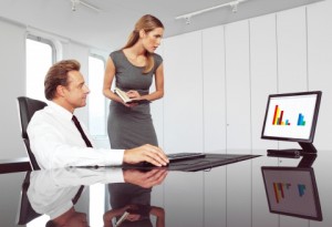 man and woman looking at computer