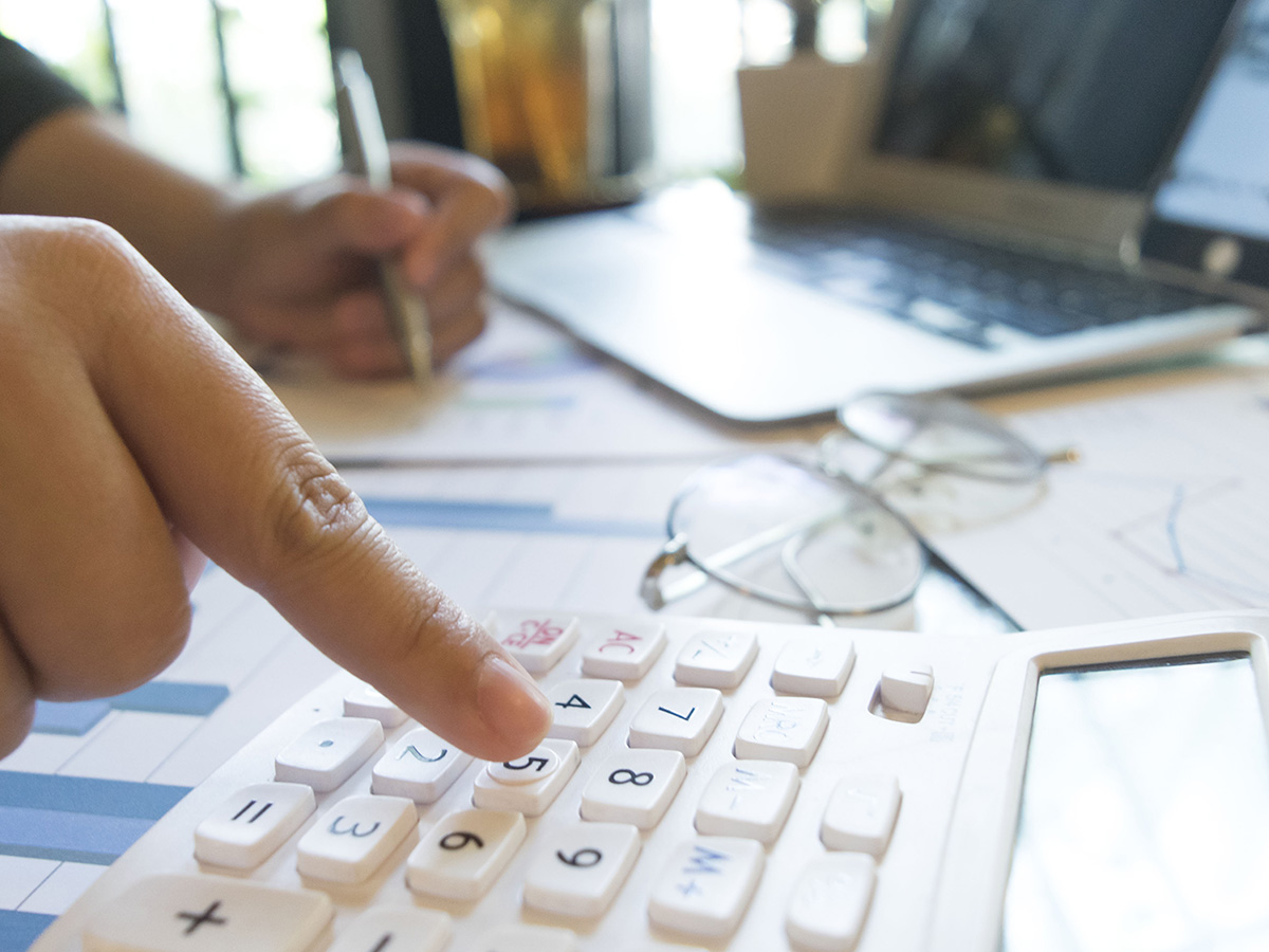 Man using calculator on desk